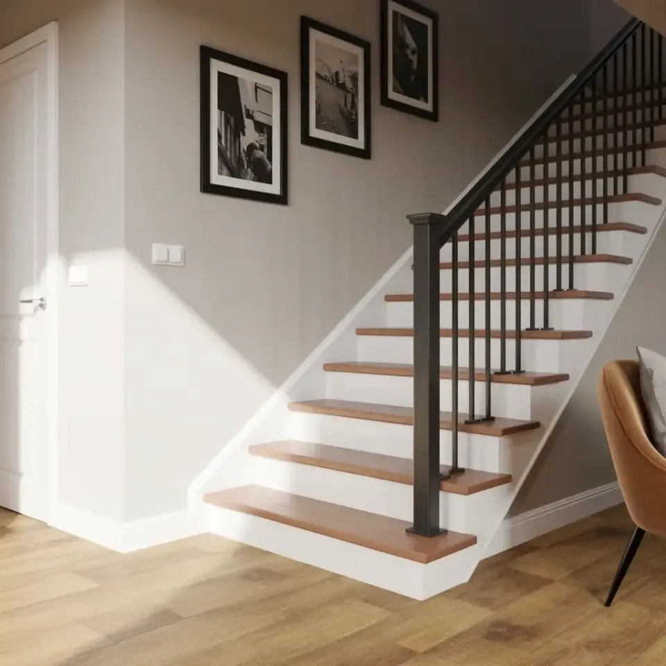 Modern staircase with black railing and a vertical photo gallery wall